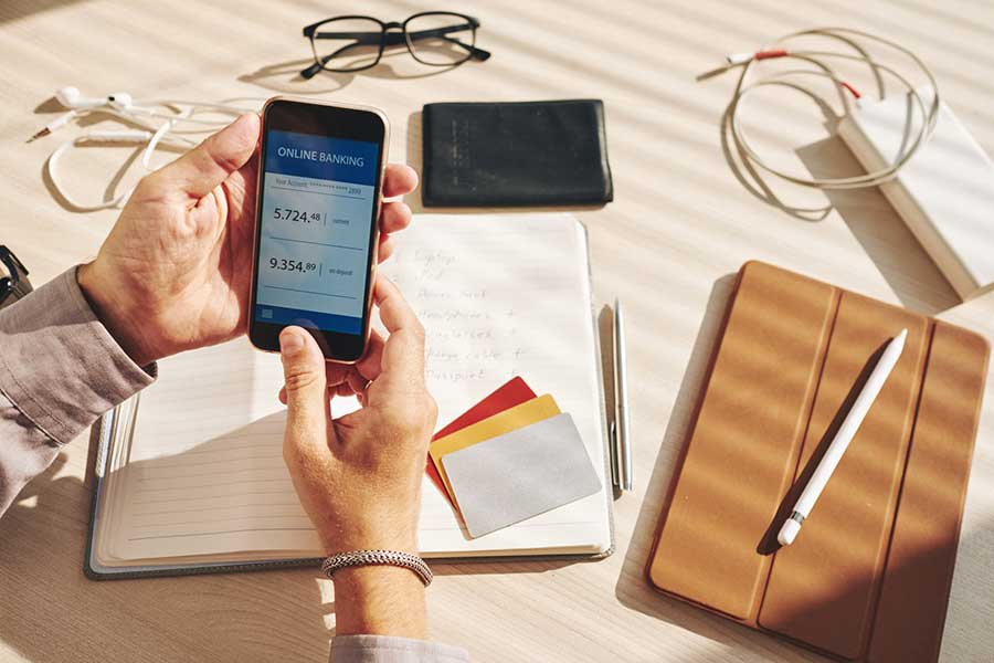 man checking bank account on phone